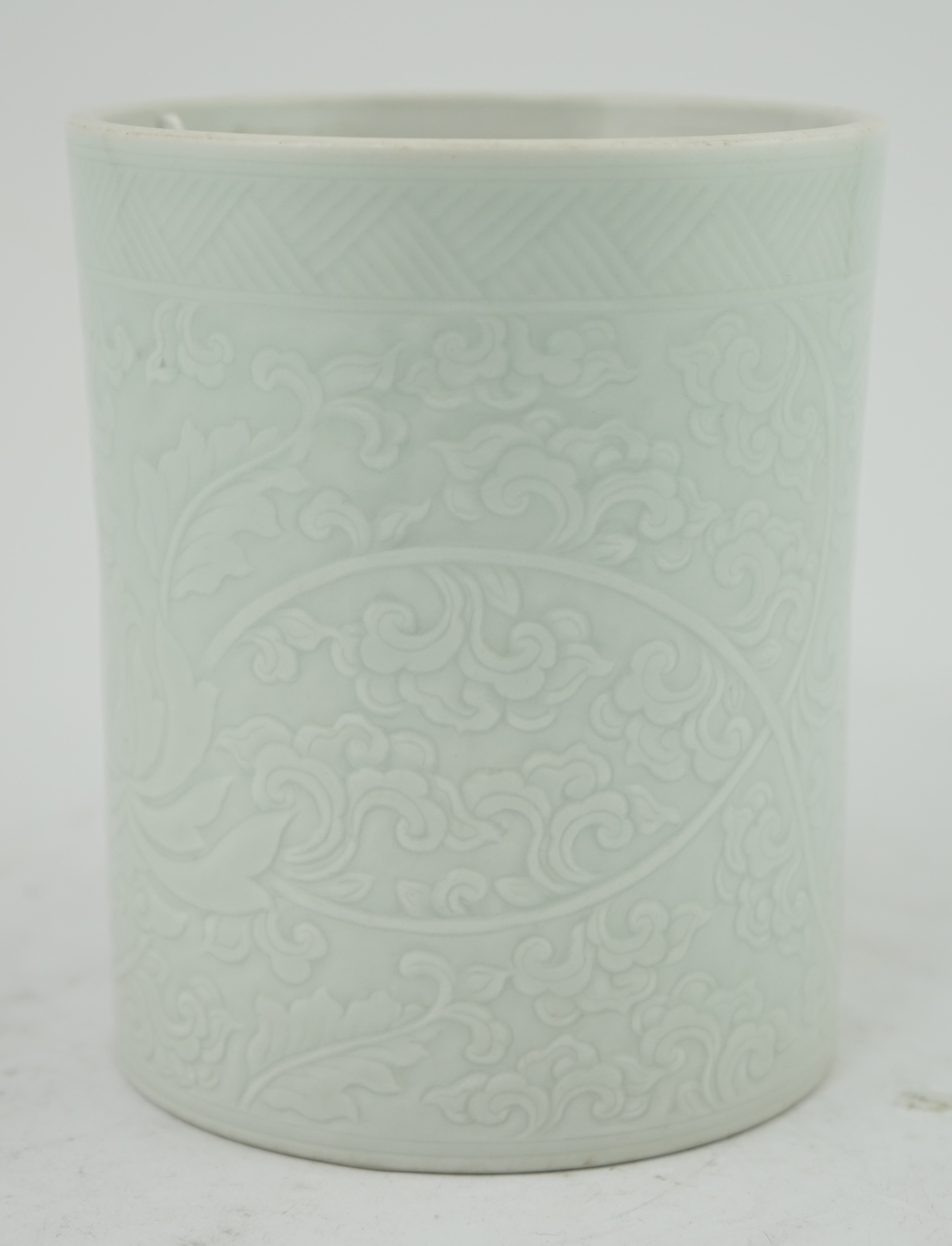 A Chinese celadon glazed brush pot, Kangxi style, 15.5cm high. Condition - good